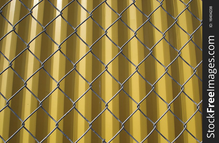 Wired fence in front of container background. Wired fence in front of container background