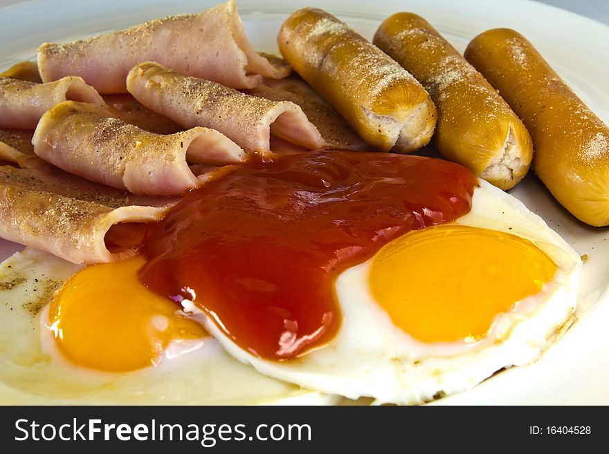 Breakfast with fire egges, hot dogs and boiled ham