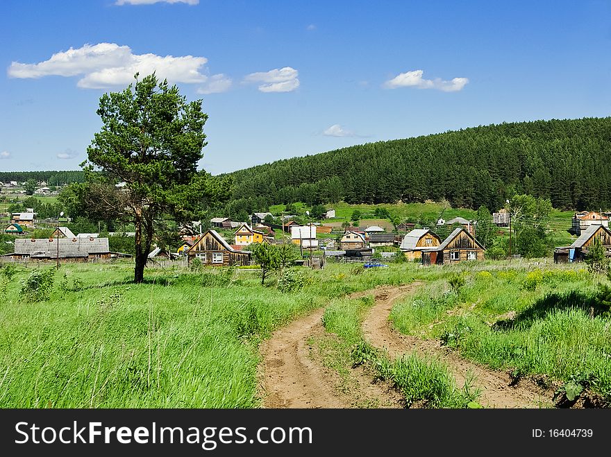 Summer landscape with a country road going to the Russian village. Summer landscape with a country road going to the Russian village