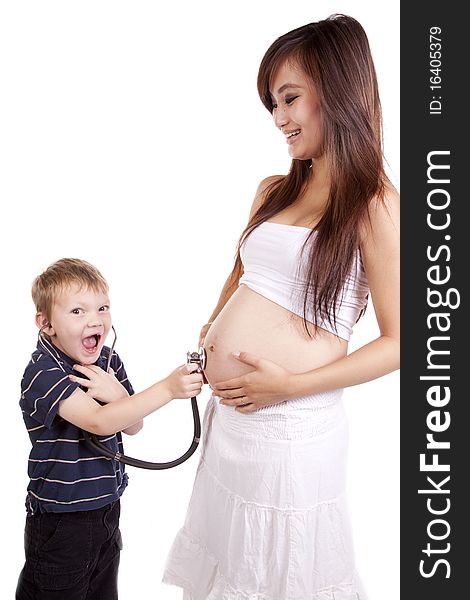 A childs hand is holding a stethoscope on the belly of a pregnant woman. A childs hand is holding a stethoscope on the belly of a pregnant woman.