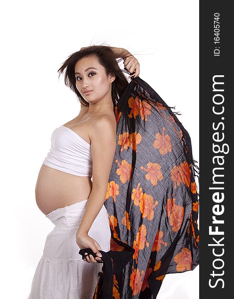 A pregnant woman is holding a sarong. A pregnant woman is holding a sarong