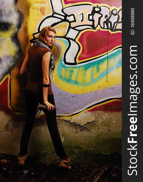 Model standing close to a graffiti wall. Model standing close to a graffiti wall