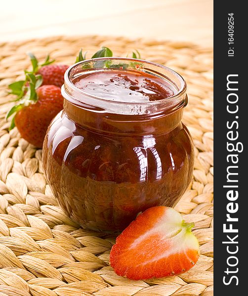 Red strawberries jam and glass jar. Red strawberries jam and glass jar