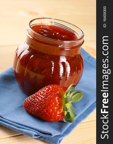 Red strawberries jam and glass jar. Red strawberries jam and glass jar