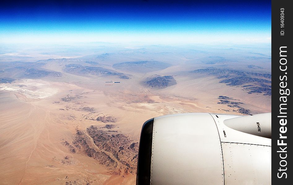 View from the plane flying over the desert. View from the plane flying over the desert