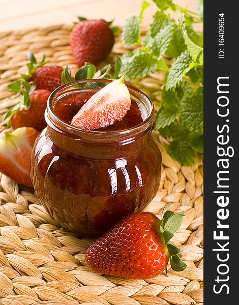 Red strawberries jam and glass jar. Red strawberries jam and glass jar