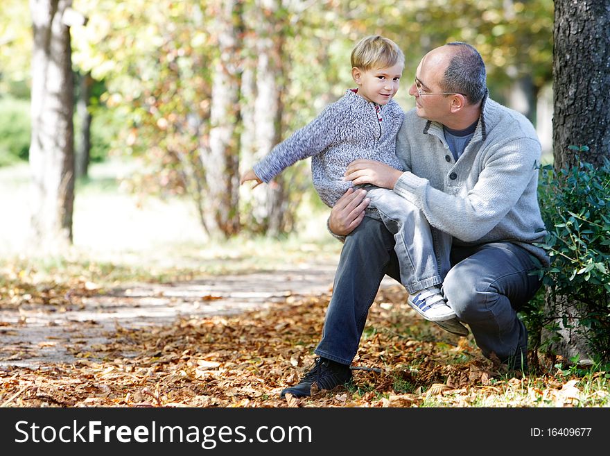 Father and son in autumn park. Father and son in autumn park