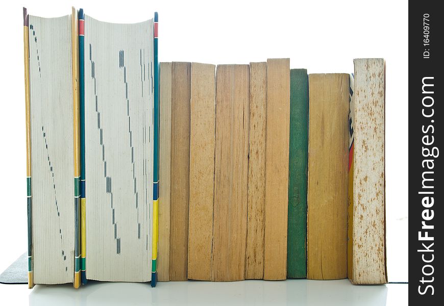 Stack of used books on white table and background