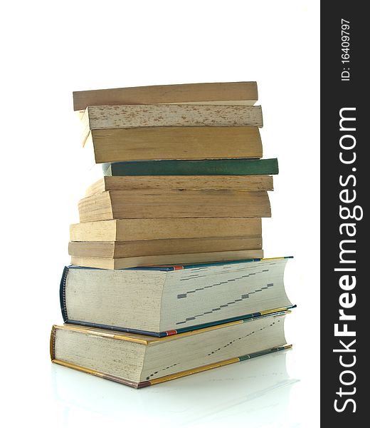 Stack of used books on white table and background