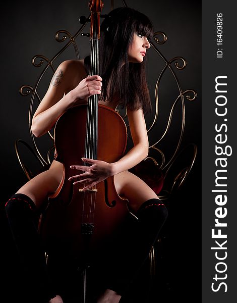 Beautiful brunette girl with cello
