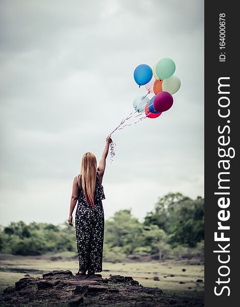 Young woman hand holding  balloons