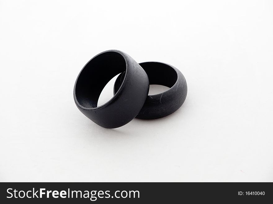 Two black wooden bracelets isolated on white background. Two black wooden bracelets isolated on white background