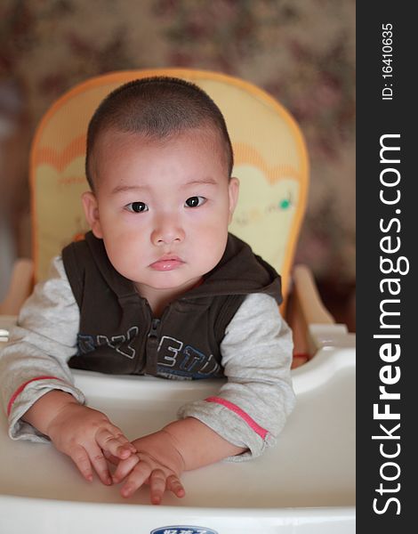 Lovely chinese baby sitting on a chair. Lovely chinese baby sitting on a chair