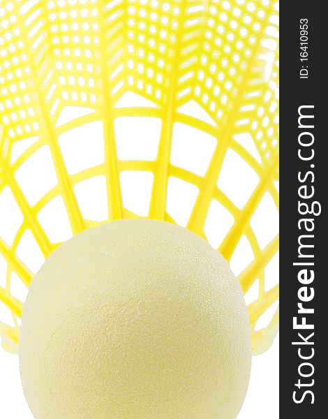 Close-up of a bright yellow badminton shuttlecock on a white background.