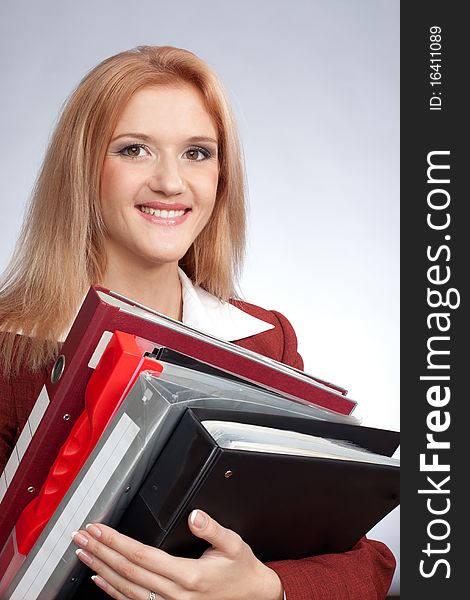 Close up of the smiling young woman with folders. Close up of the smiling young woman with folders
