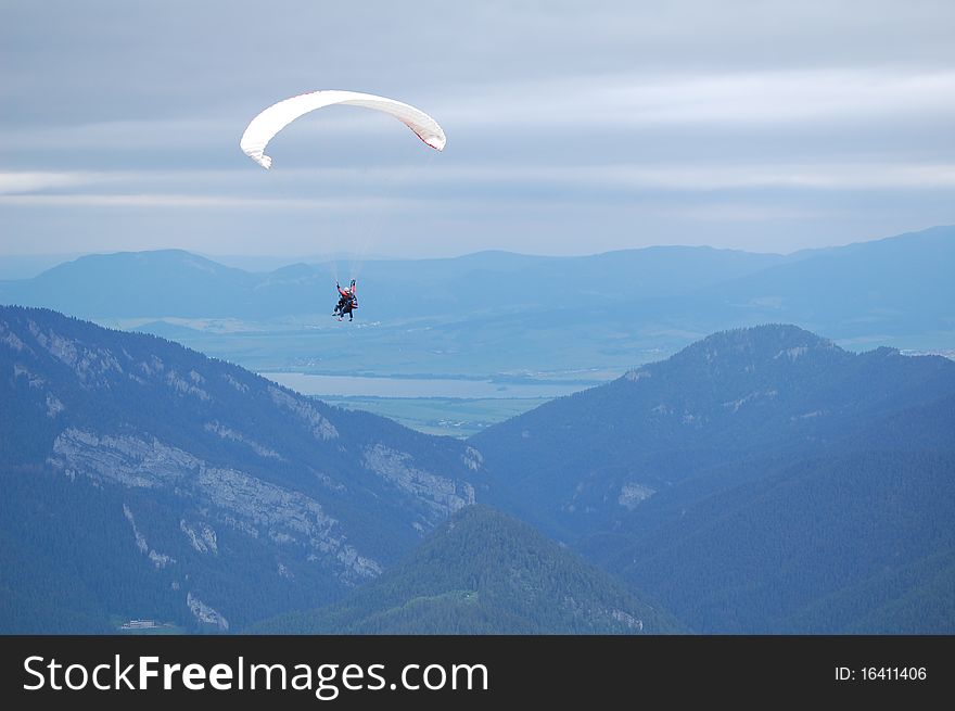 Tandem paragliding in High Tatras, Slovakia. Summer time in mountains. Tandem paragliding in High Tatras, Slovakia. Summer time in mountains.