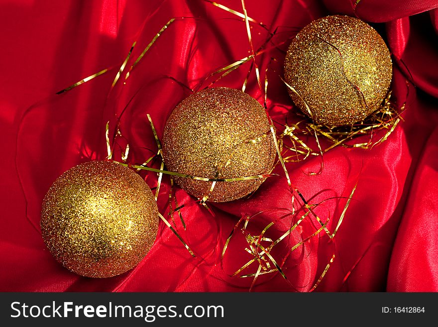 Christmas decoration. Gold Christmas balls on red background