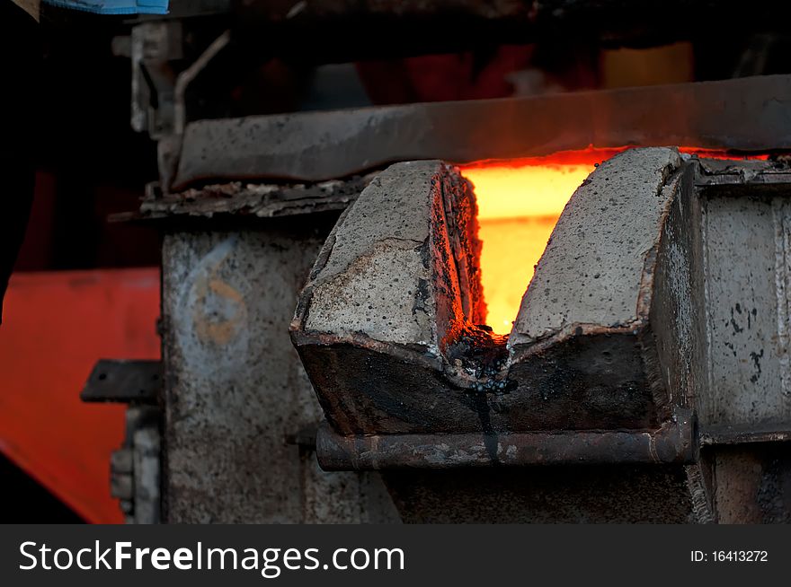 Molten metal is poured in a foundry. Molten metal is poured in a foundry