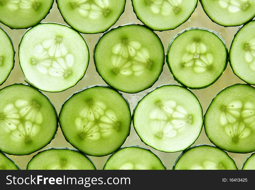 Many circles of fresh cucumber for background. Many circles of fresh cucumber for background