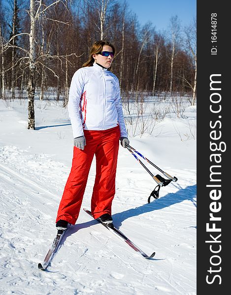 Girl on skis in the winter forest