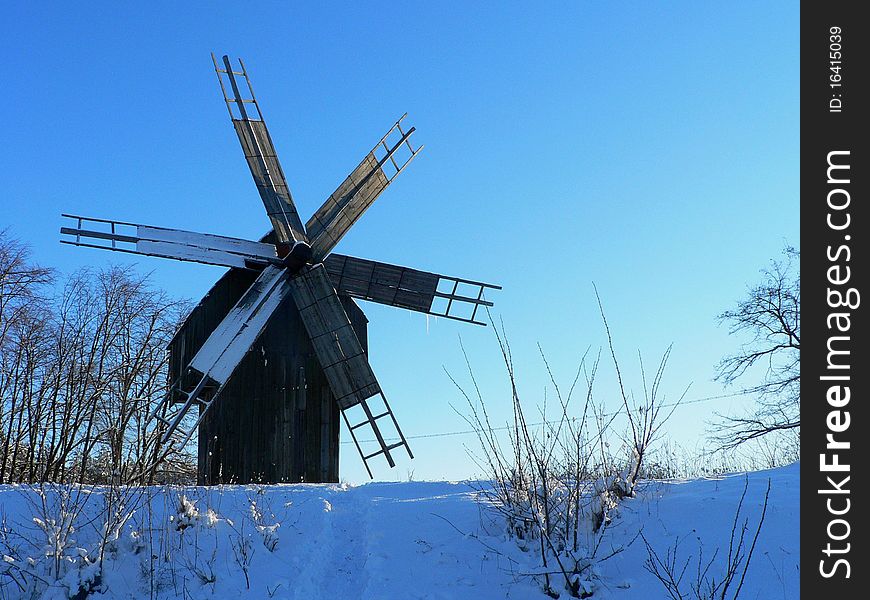 Windmill in winter time in Western Ukraine near road. Windmill in winter time in Western Ukraine near road