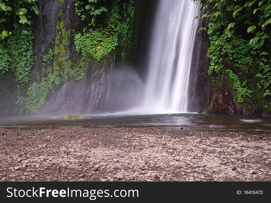 A waterfall in the foresty landscape of Bali. A waterfall in the foresty landscape of Bali