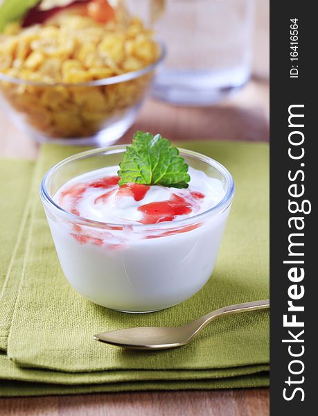 Bowl of yogurt, corn flakes in the background