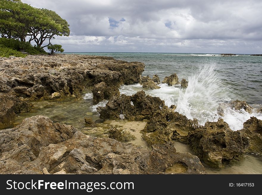 Wave crashing on rocks on the Island of Oahu in Hawaii. Wave crashing on rocks on the Island of Oahu in Hawaii