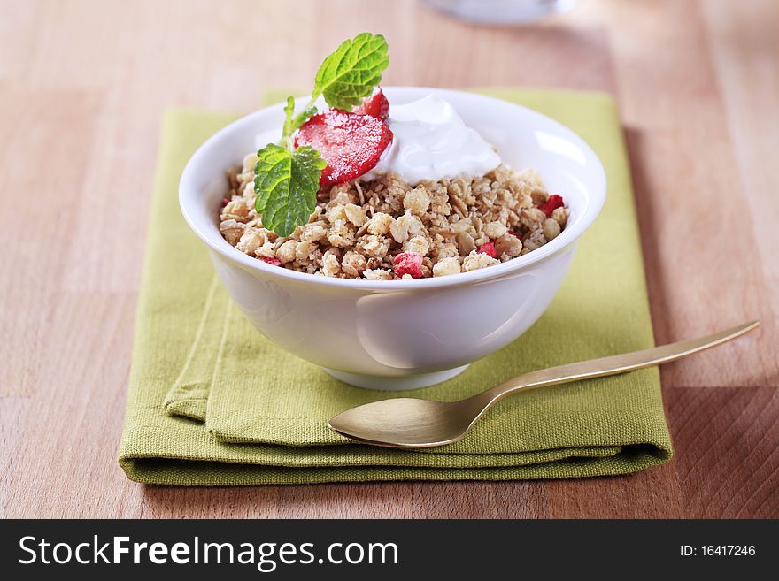 Bowl of breakfast cereal and white yogurt