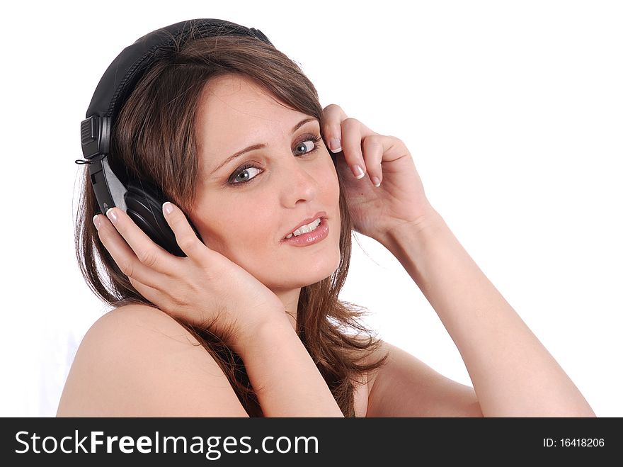 Girl listening to musicthrough headphones isolated on white.