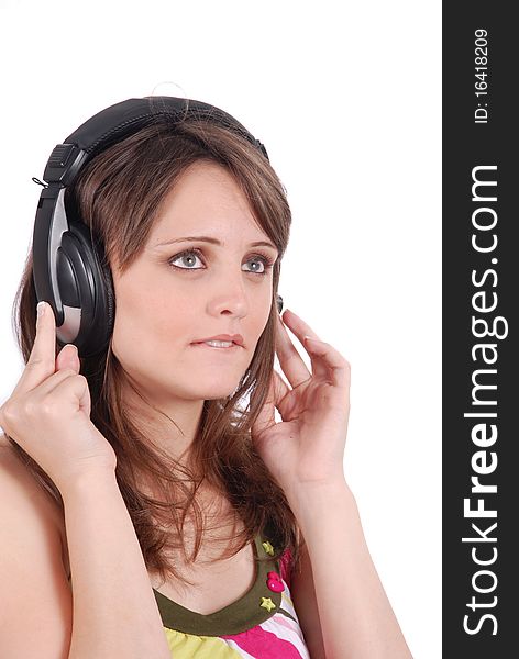 Girl listening to musicthrough headphones isolated on white.