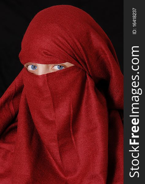 Slamic girl wearing a hijab against a black background. Slamic girl wearing a hijab against a black background.