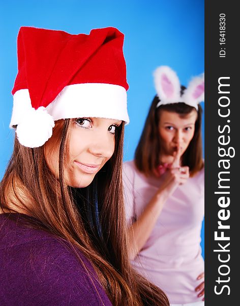 Two Christmas girls on a blue background. Two Christmas girls on a blue background.