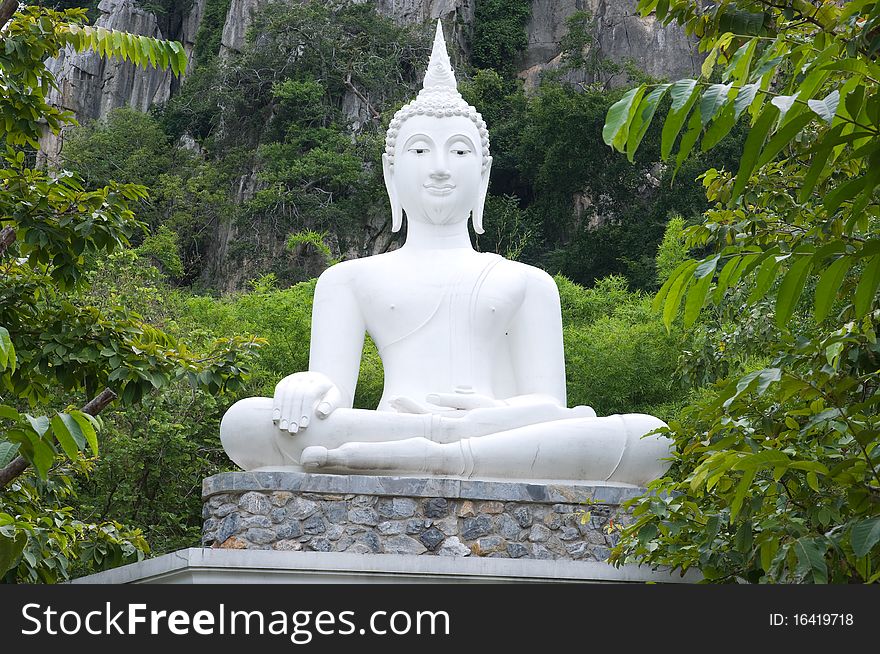 White statue buddha image on the mountain Thailand