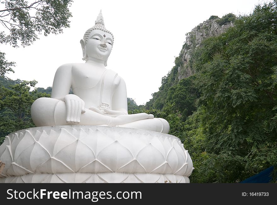 White statue buddha image on the mountain Thailand