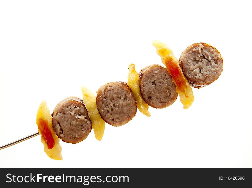Coarse fried sausage with Fries on spit
