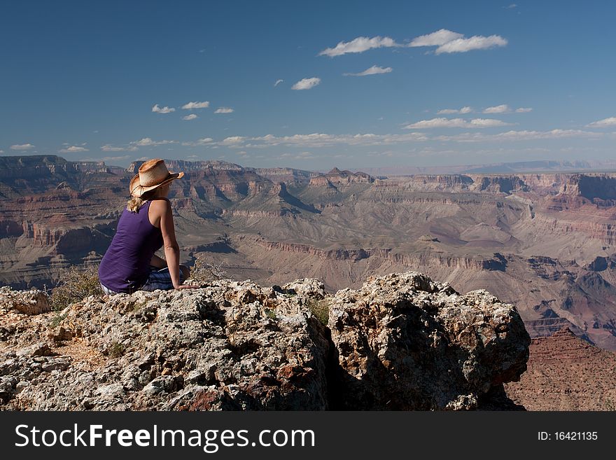 A woman staring on top of a mountain at the canyons in USA. A woman staring on top of a mountain at the canyons in USA