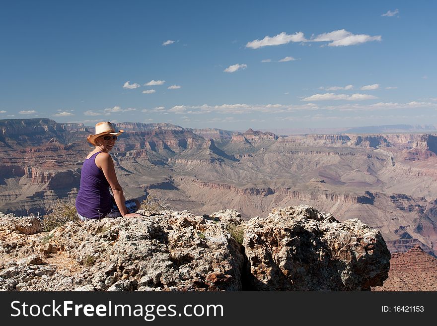 A woman posing on top of a mountain at the canyons in USA. A woman posing on top of a mountain at the canyons in USA