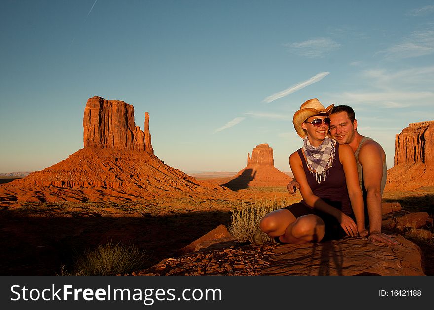 A portrait of a love couple laughing in front of a rock found in monument valley utah. A portrait of a love couple laughing in front of a rock found in monument valley utah