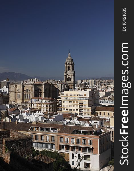 Málaga scenery represented by the tower of Málaga cathedral and the modern buildings.