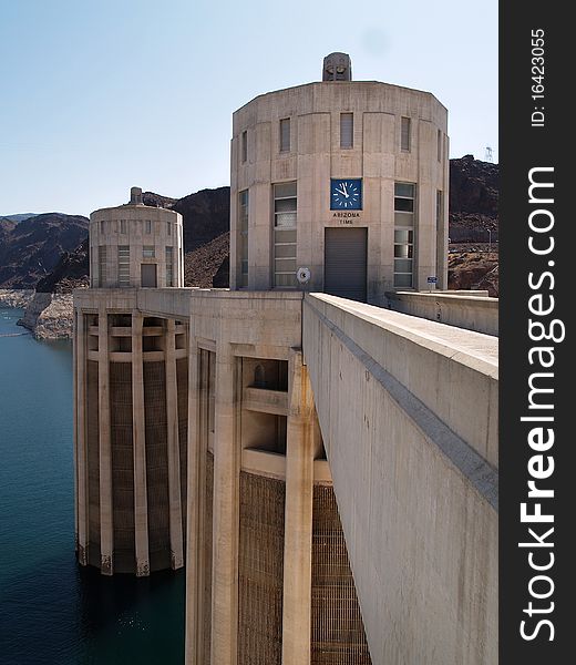 Hoover Dam's sculptured turrets, clock faces on the intake towers set for the time in Arizona. Hoover Dam's sculptured turrets, clock faces on the intake towers set for the time in Arizona.