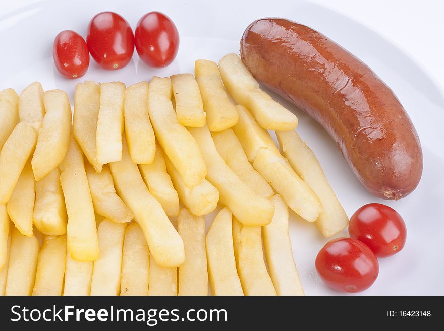Fried potato with tomatoes and sausage on a plate.