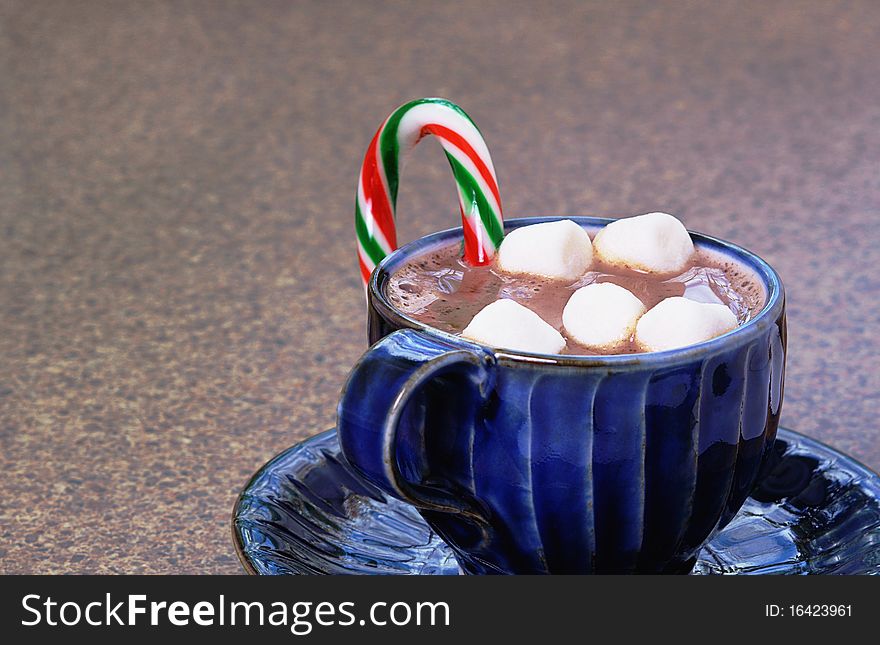 Christmas drink made with milk topped with mini marshmallows flavored with striped candy cane. Christmas drink made with milk topped with mini marshmallows flavored with striped candy cane