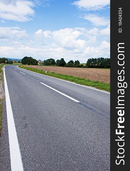 Straight asphalt road leading into the distance