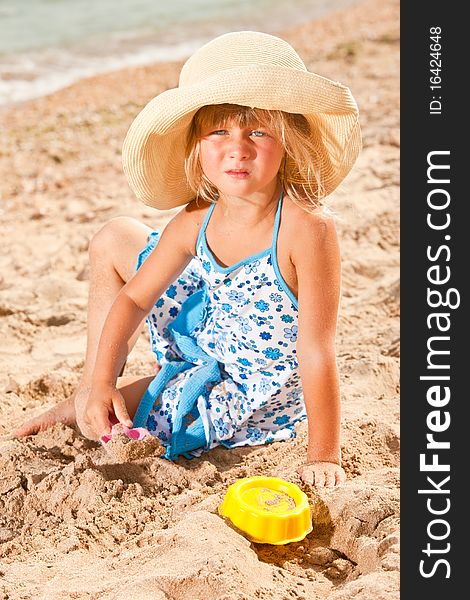 People series: little girl on sea beach are play the sandy game
