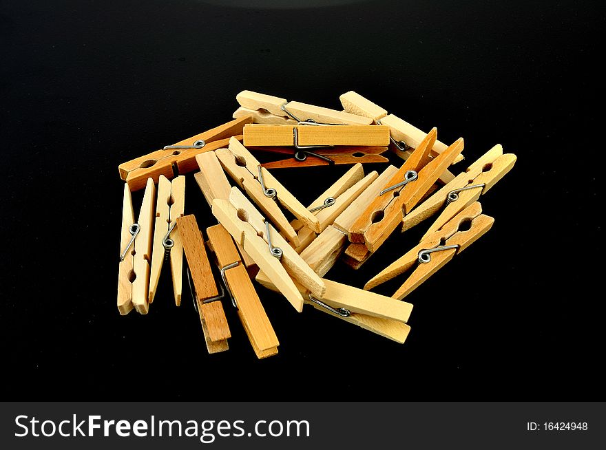 Wooden clothespeg isolated on a black background