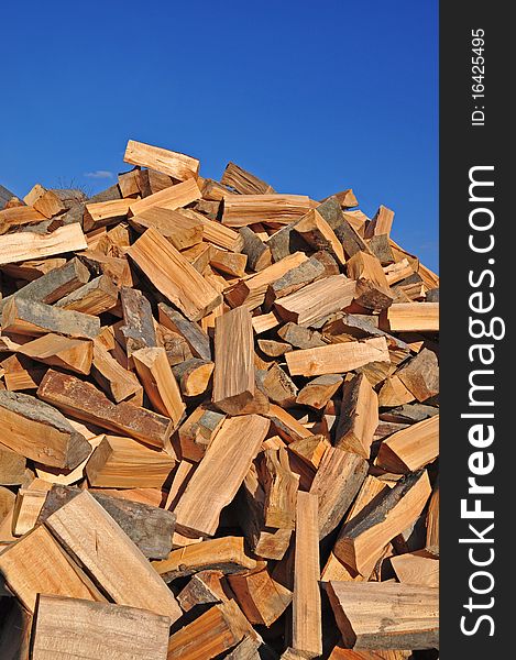 Fire wood fallen down on a heap in chaotic position against the dark blue sky. Fire wood fallen down on a heap in chaotic position against the dark blue sky.