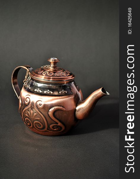 A metal tea pot graved artistically