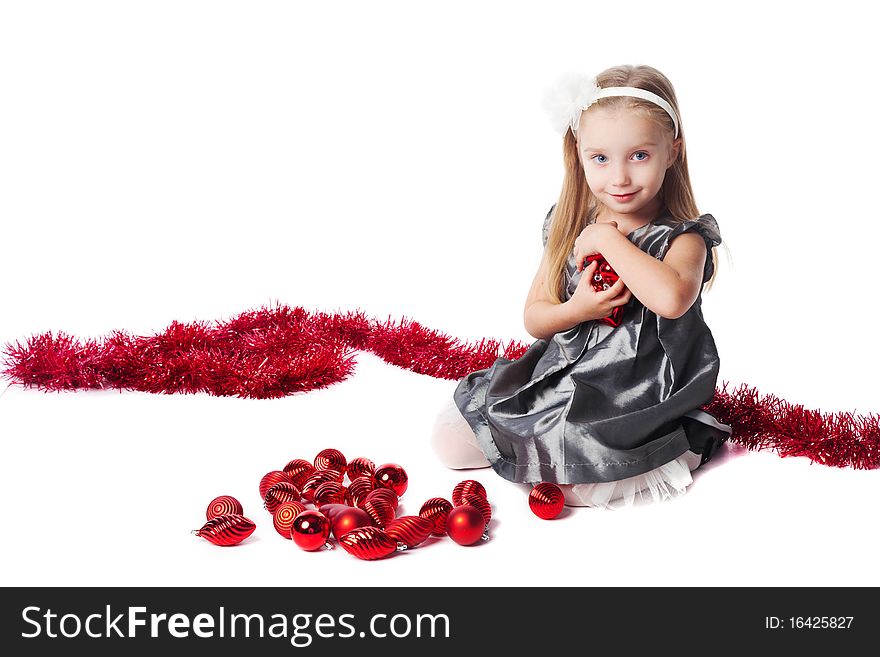 Smiling little girl with red new year toys isolated. Smiling little girl with red new year toys isolated