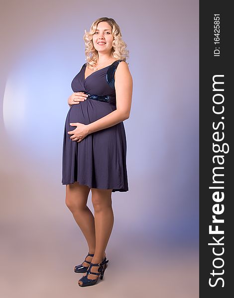 Photo Of Expectant Mother In A Dark Blue Dress